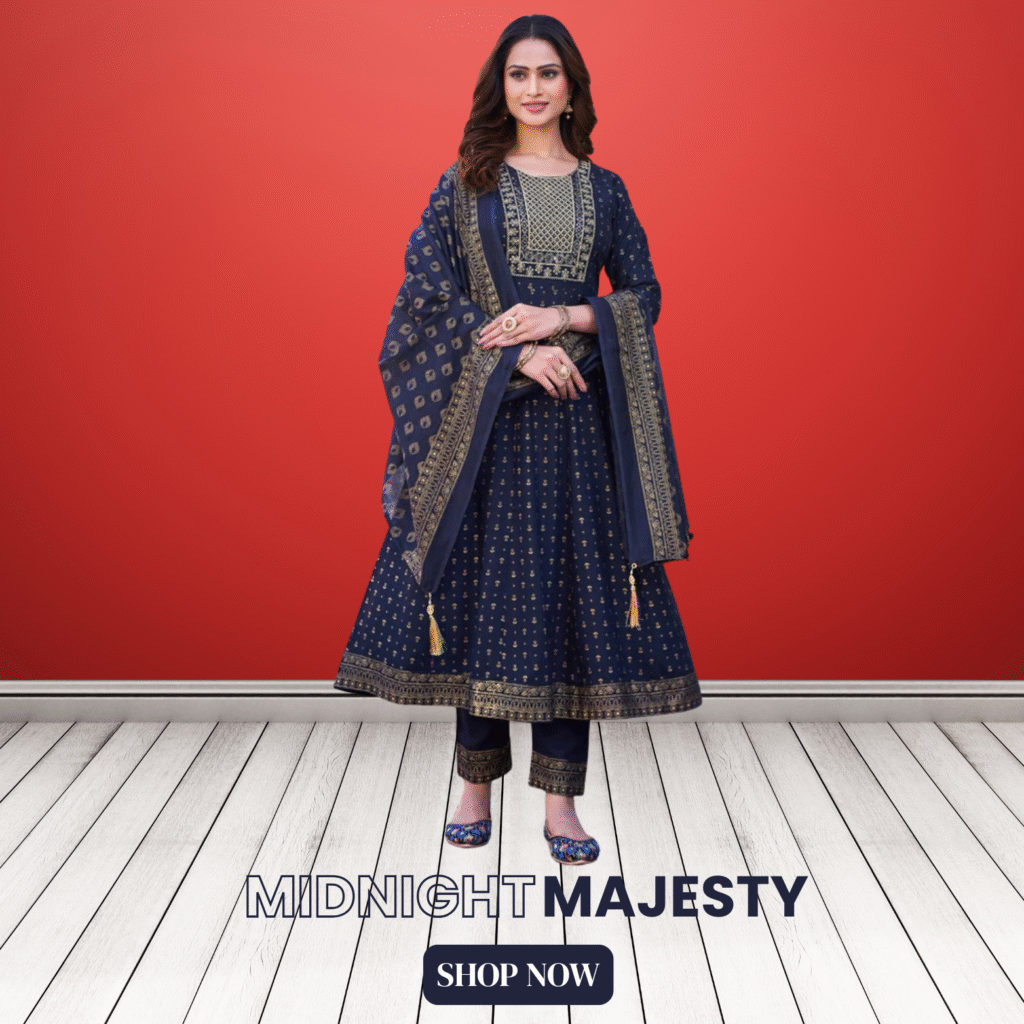 Woman wearing a navy blue Anarkali suit with intricate golden embroidery, paired with matching pants and a printed dupatta, standing on a white wooden floor against a bold red background. Text on the image reads "MIDNIGHT MAJESTY" and "SHOP NOW"