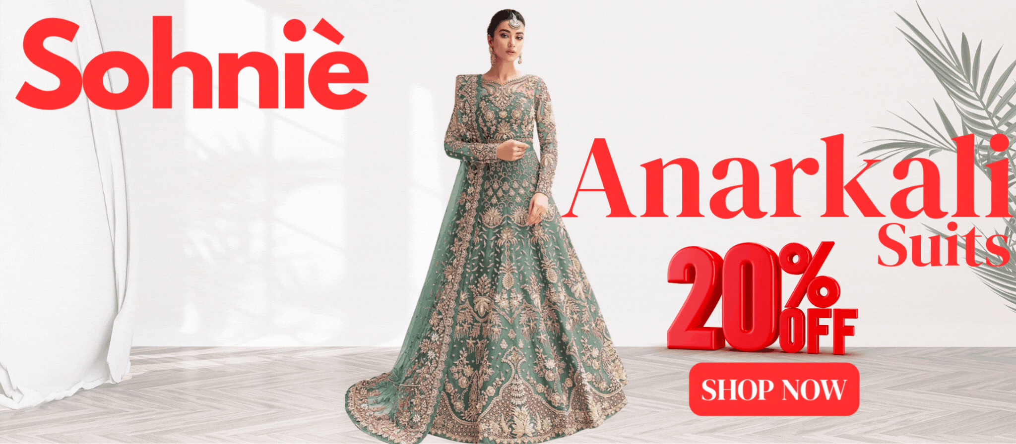 Promotional banner for Sohniè featuring a woman in an intricately embroidered green Anarkali suit. The image highlights 20% OFF on Anarkali Suits with a bold red "SHOP NOW" button. The backdrop includes a minimal white interior with soft lighting and plant accents.